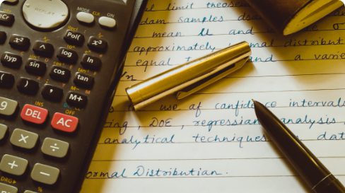 Acalculator and a legal pad with calculations on it;